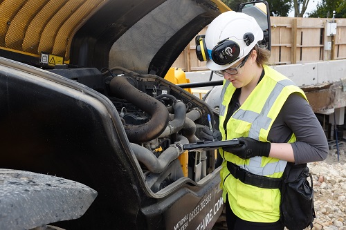 Lady Inspecting Construction Machine Cleaner Construction for London