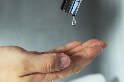 Tap Dripping on Hand iStock liulolo