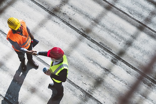 Construction workers shaking hands