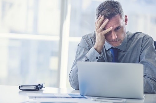 Stressed Man at Laptop iStock